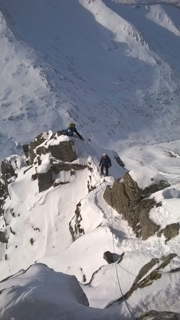 Some climbers working their way up a snowy mountain