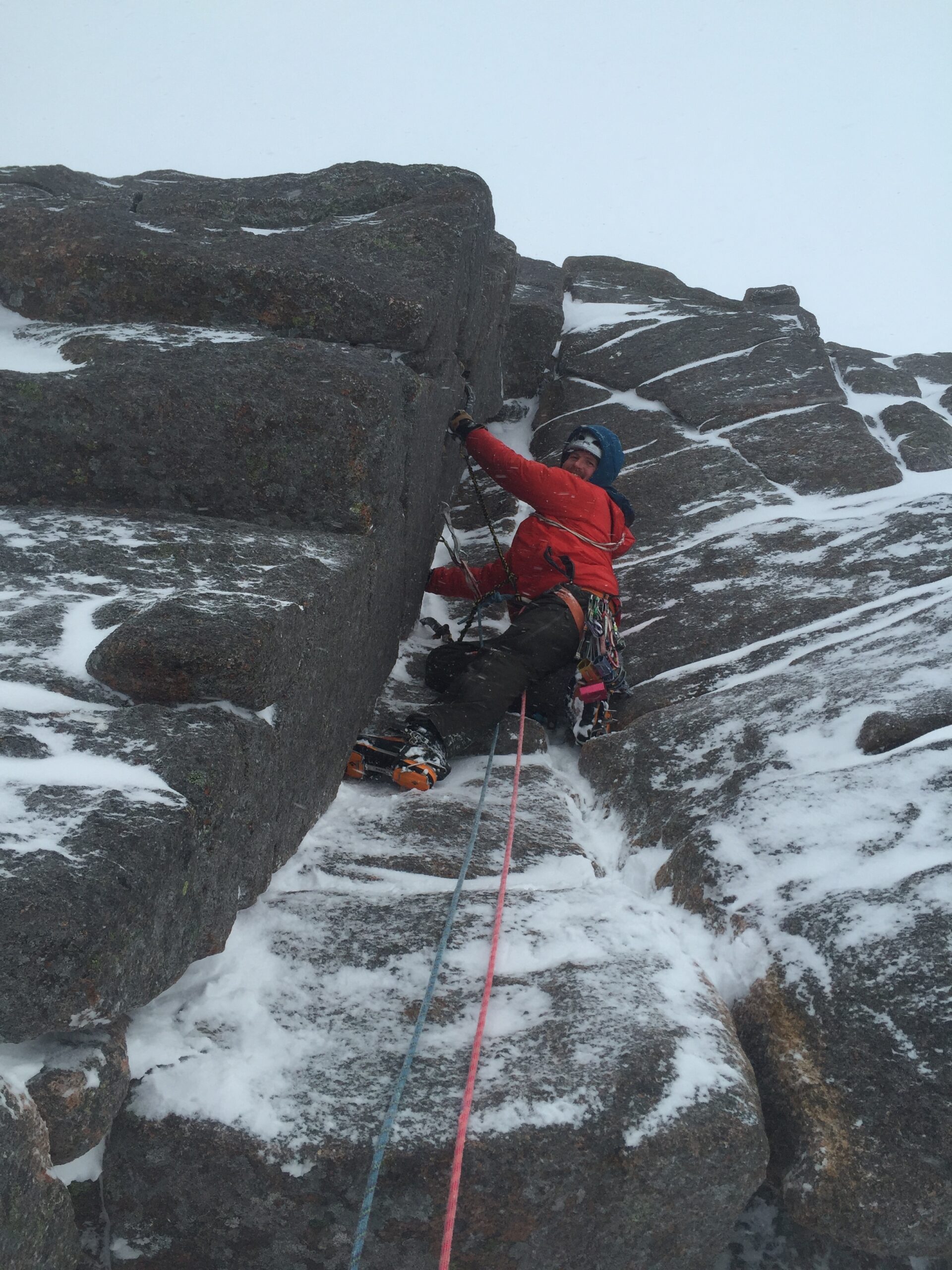 Tim leading a climb up a snowy rockface